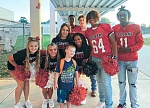 James Street Elementary student Kyler Ritchey was thrilled to be greeted by Coldspring-Oakhurst High School football players and cheerleaders as he arrived at school on Friday, Sept. 16, in honor of Homecoming Week.. Photo by Feather Wilson